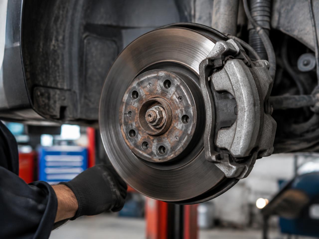 Brake disc and caliper on a car in the workshop